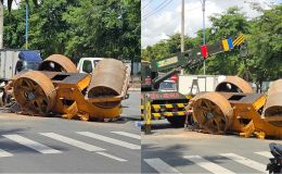 Lý do xe lu rơi, lật ngang giữa đường ở TP HCM, người đàn ông ôm bé trai thoát nạn trong gang tấc