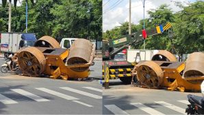 Lý do xe lu rơi, lật ngang giữa đường ở TP HCM, người đàn ông ôm bé trai thoát nạn trong gang tấc