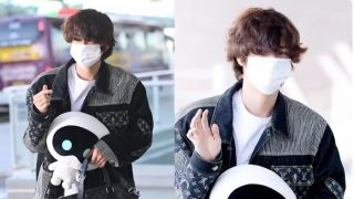 Jin (BTS) bị bắt gặp ớ sân bay Argentina, ôm 1 nhân vật lạ trong tay