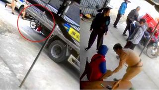 Nữ shipper bị cuốn vào gầm xe tải vì mải nghe điện thoại, camera ghi lại khoảnh khắc được CSGT cứu sống