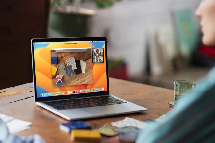 A-MacBook-Pro-M2-sits-on-a-wooden-table-with-a-nice-bokeh-background-jpg